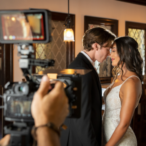 couple kissing behind the scenes Austin Trevor Barone Filming Wedding Photographer Filmmakers sprengergarten space coast